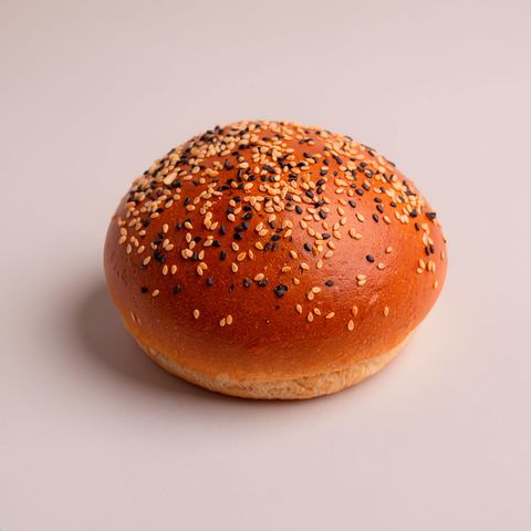 A burger bun topped with mixed white and black sesame